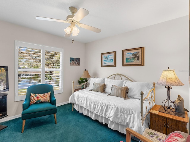 bedroom with ceiling fan, dark carpet, and baseboards