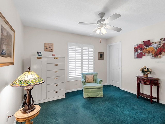 sitting room featuring carpet flooring, a ceiling fan, and baseboards