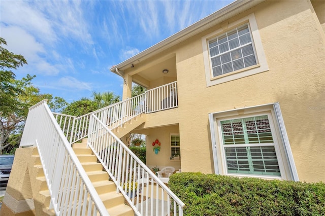 exterior space with stucco siding and stairs