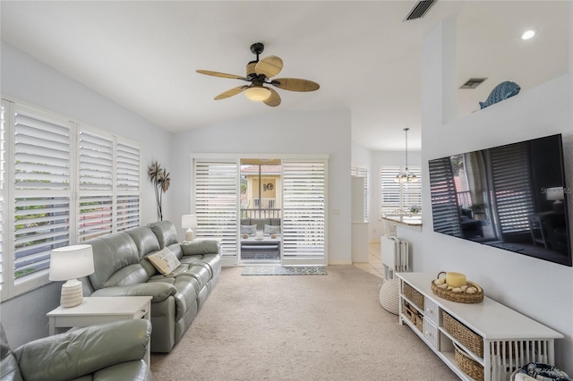 carpeted living area with visible vents, lofted ceiling, and ceiling fan