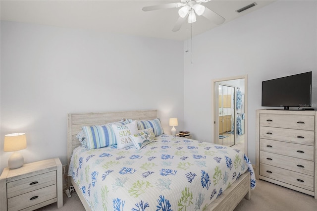 bedroom featuring ensuite bathroom, a ceiling fan, visible vents, and carpet floors