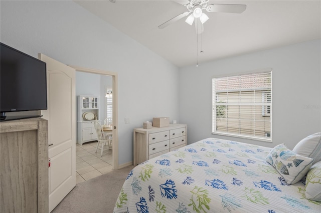 bedroom featuring lofted ceiling, light colored carpet, and ceiling fan