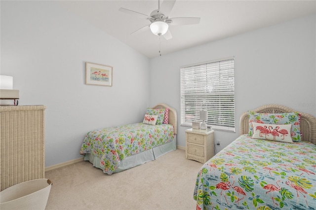 carpeted bedroom with vaulted ceiling, baseboards, and ceiling fan