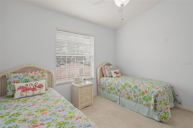 bedroom featuring ceiling fan, baseboards, and carpet