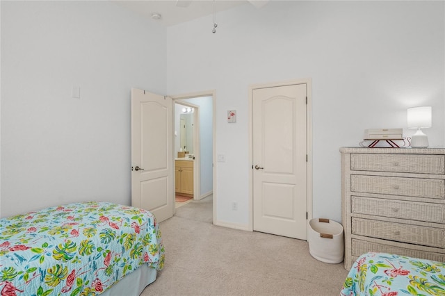 bedroom with baseboards and light carpet