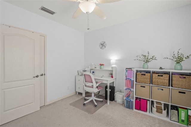 carpeted office space with visible vents and ceiling fan