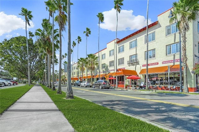 view of road with sidewalks, curbs, and street lighting