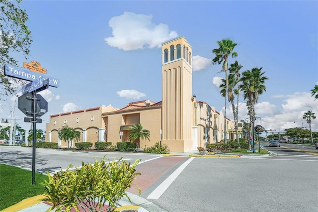 view of building exterior featuring uncovered parking