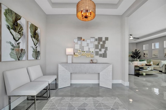 6027 White Mangrove Ln, Bradenton, FL 34210 - interior space with a raised ceiling, ceiling fan with notable chandelier, and baseboards