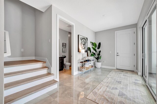 6027 White Mangrove Ln, Bradenton, FL 34210 - foyer with stairs, baseboards, and marble finish floor