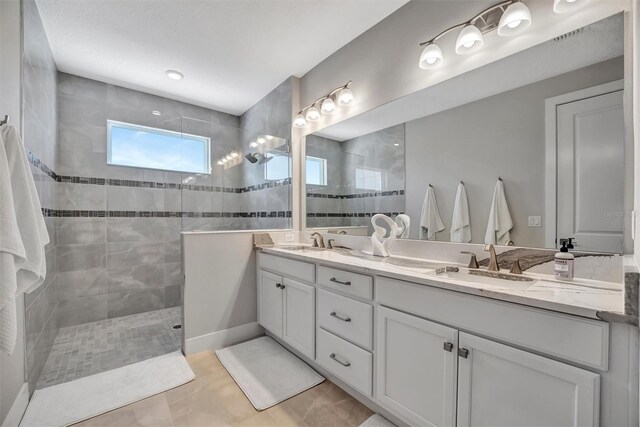 6027 White Mangrove Ln, Bradenton, FL 34210 - bathroom featuring a sink, double vanity, and a walk in shower