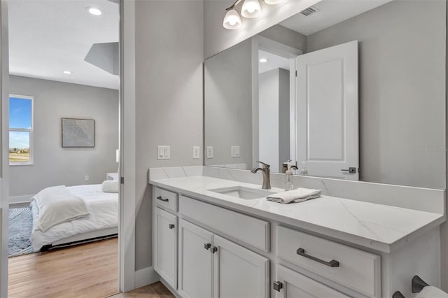 6027 White Mangrove Ln, Bradenton, FL 34210 - bathroom featuring visible vents, connected bathroom, recessed lighting, wood finished floors, and vanity