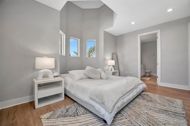 6027 White Mangrove Ln, Bradenton, FL 34210 - bedroom with recessed lighting, wood finished floors, baseboards, and ensuite bathroom