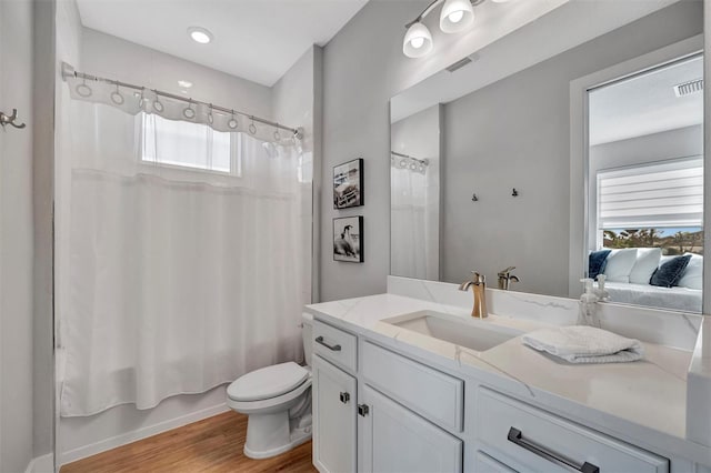 6027 White Mangrove Ln, Bradenton, FL 34210 - ensuite bathroom featuring visible vents, toilet, shower / tub combo, wood finished floors, and vanity