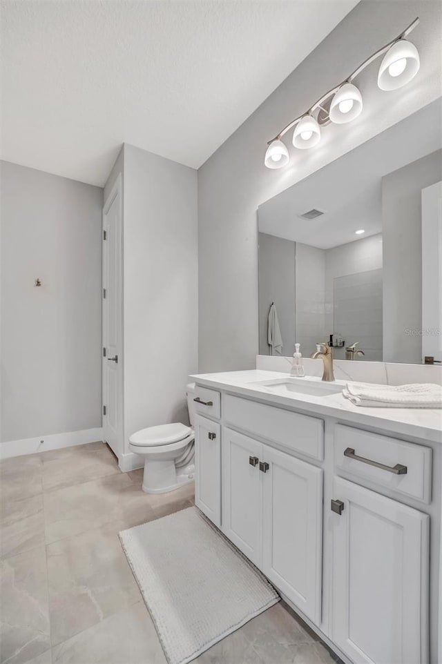 6027 White Mangrove Ln, Bradenton, FL 34210 - full bathroom featuring visible vents, baseboards, toilet, and vanity