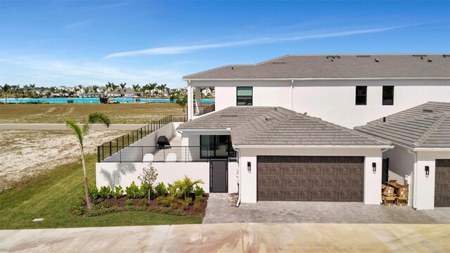 6027 White Mangrove Ln, Bradenton, FL 34210 - view of front of house featuring stucco siding, an attached garage, and a tile roof