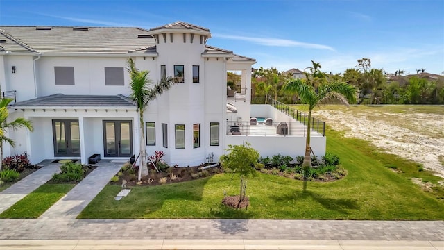 6027 White Mangrove Ln, Bradenton, FL 34210 - view of front of house featuring a tiled roof, stucco siding, french doors, and a front lawn