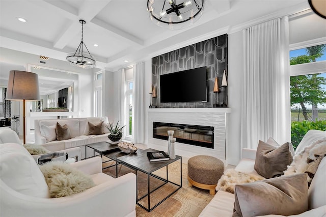 living room featuring coffered ceiling, a fireplace, recessed lighting, beamed ceiling, and a notable chandelier