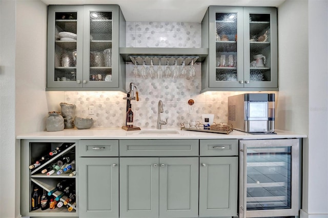 bar featuring wet bar, beverage cooler, backsplash, and a sink