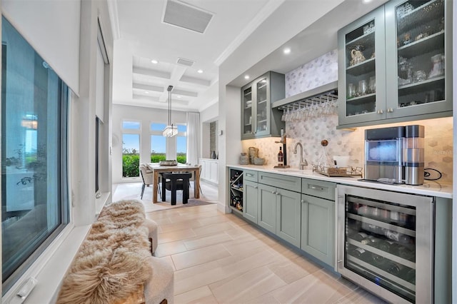 bar featuring visible vents, beverage cooler, a sink, backsplash, and indoor wet bar