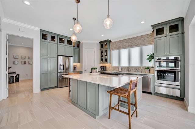 kitchen with backsplash, crown molding, a kitchen breakfast bar, stainless steel appliances, and a warming drawer