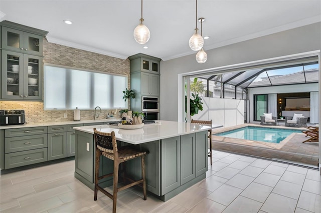 kitchen with green cabinetry, a sink, ornamental molding, and light countertops