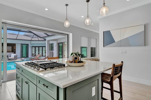 kitchen featuring ornamental molding, light countertops, stainless steel gas stovetop, green cabinets, and open floor plan