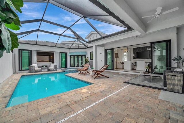 view of pool with a pool with connected hot tub, ceiling fan, a patio, outdoor lounge area, and a lanai