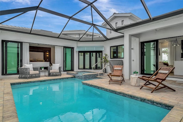 view of swimming pool featuring a lanai, a pool with connected hot tub, and a patio