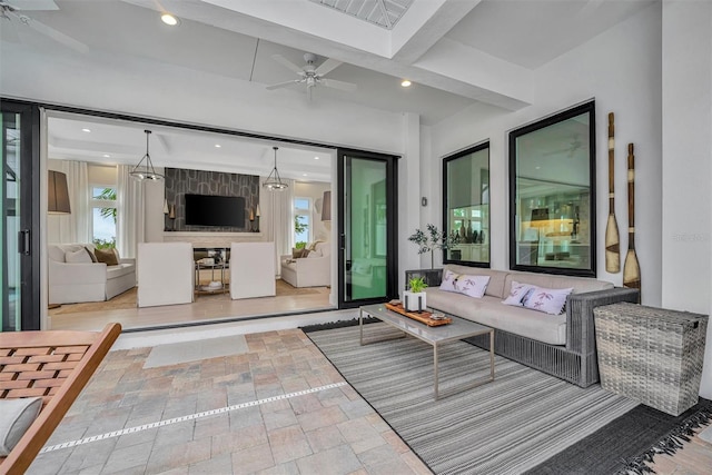 living room featuring recessed lighting, stone finish flooring, and ceiling fan