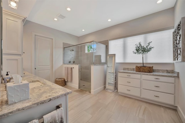 full bathroom featuring recessed lighting, a shower stall, vanity, and visible vents