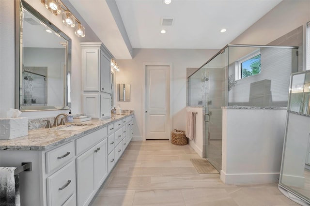 full bath featuring a shower stall, recessed lighting, double vanity, and a sink