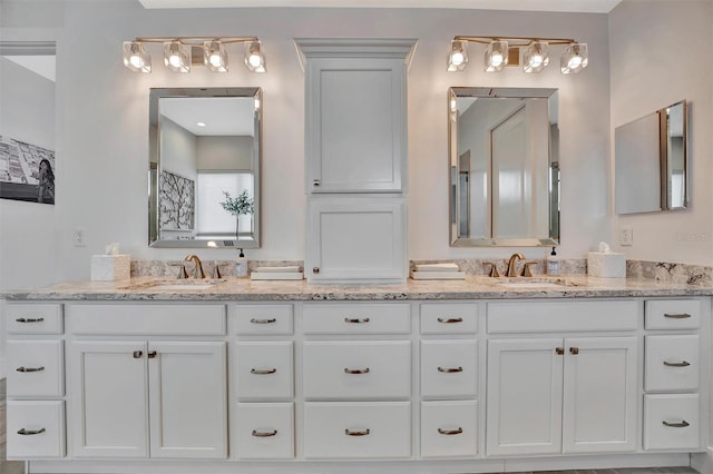 full bath with double vanity and a sink