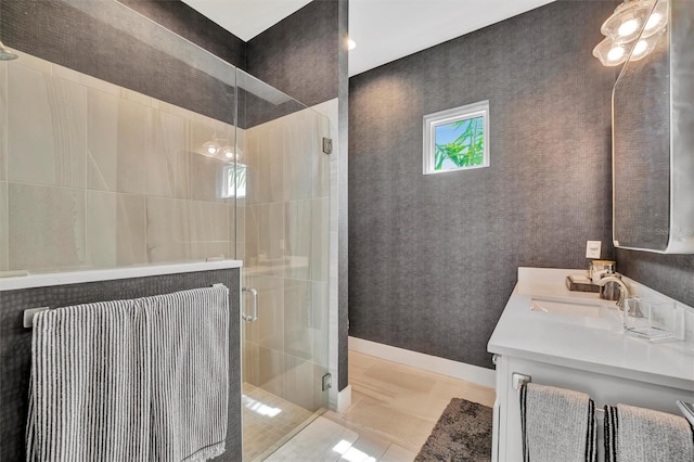 full bathroom with baseboards, a stall shower, vanity, and tile patterned flooring