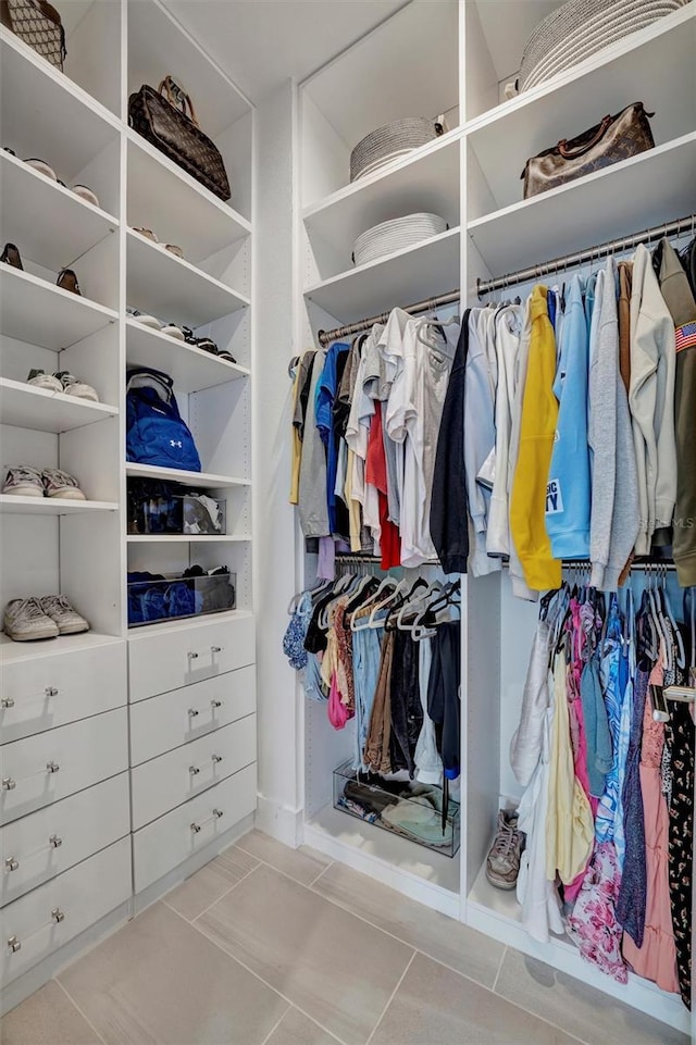 spacious closet with tile patterned floors