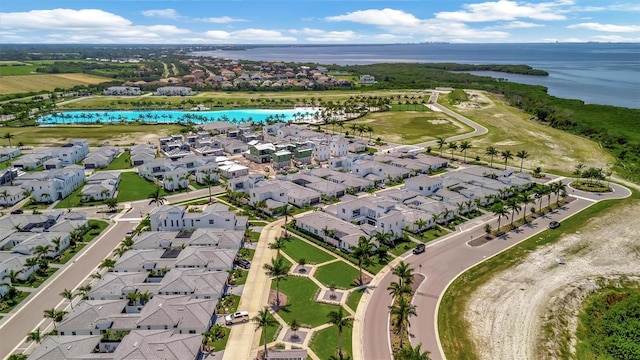 drone / aerial view featuring a residential view and a water view