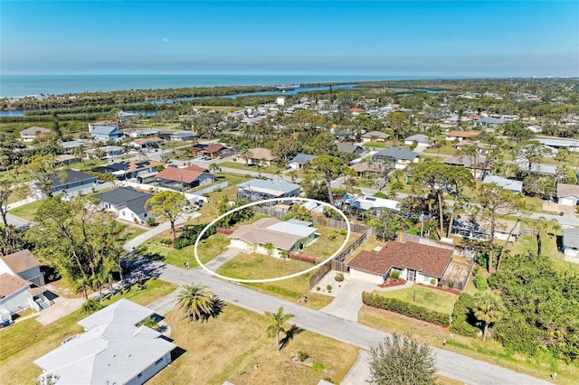 drone / aerial view with a water view and a residential view