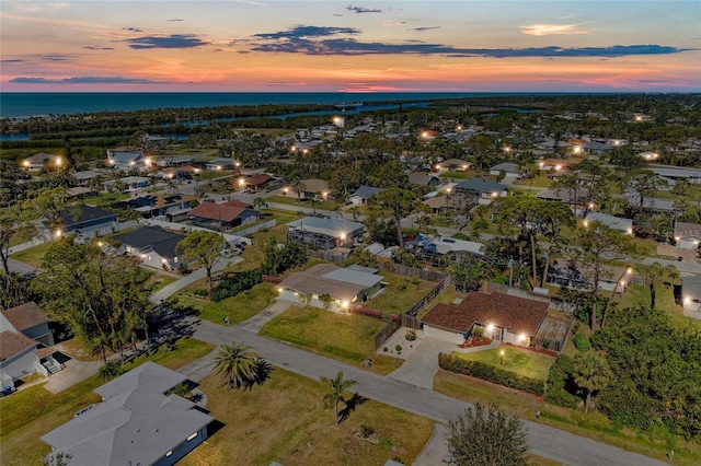 drone / aerial view featuring a residential view and a water view