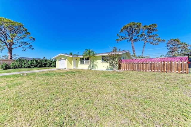 ranch-style house featuring a front lawn, fence, concrete driveway, stucco siding, and an attached garage