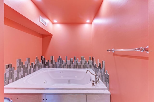 full bath with visible vents, a view of city, and a whirlpool tub