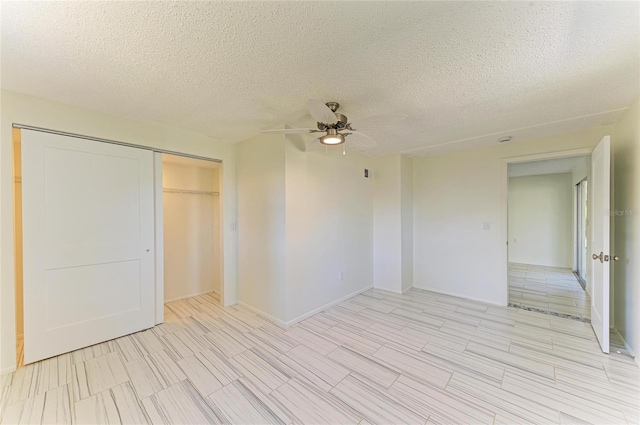 spare room featuring a textured ceiling and ceiling fan