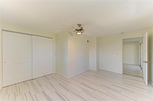 spare room with a textured ceiling and ceiling fan