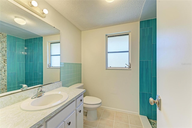 full bath featuring toilet, a textured ceiling, a tile shower, tile patterned flooring, and vanity