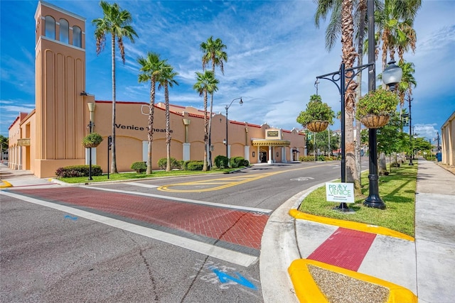 view of street with street lights, curbs, sidewalks, and a residential view