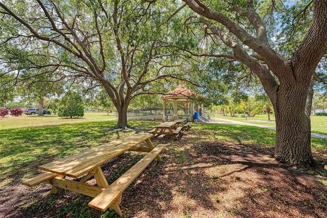 view of property's community featuring playground community and a yard