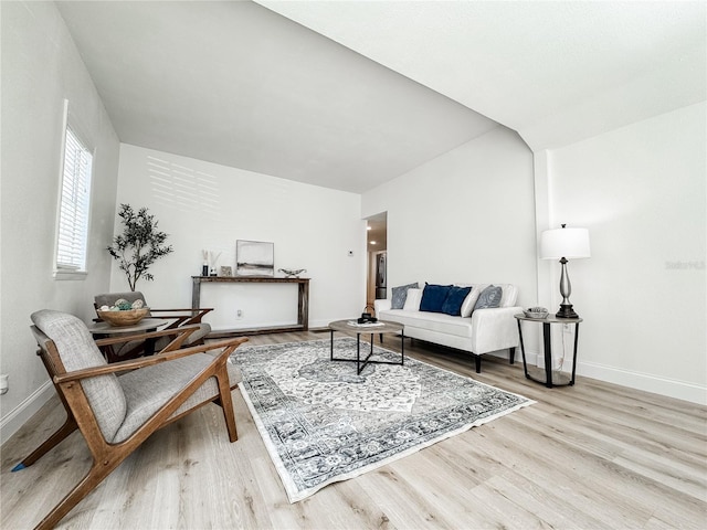 living area featuring baseboards and wood finished floors