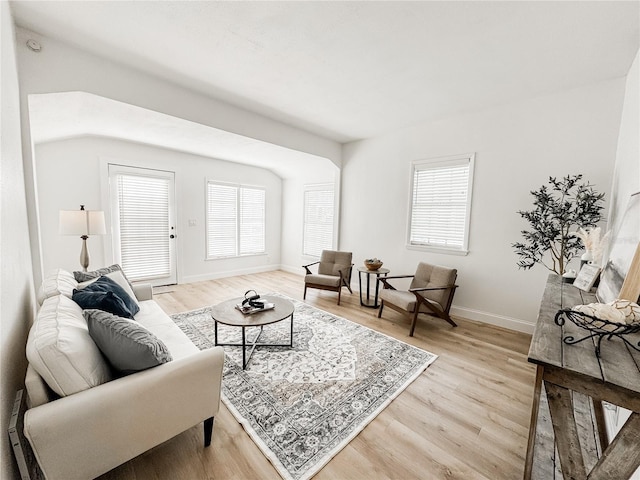 living area featuring light wood-style flooring and baseboards