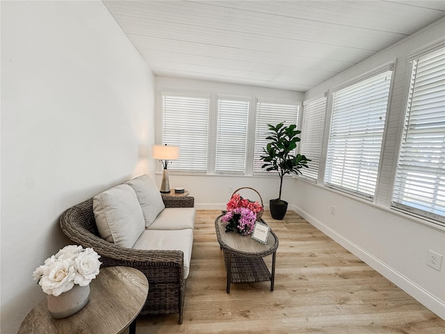 living area with light wood-style flooring and baseboards