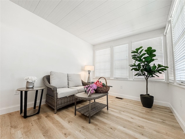 living area featuring light wood-type flooring, baseboards, and visible vents