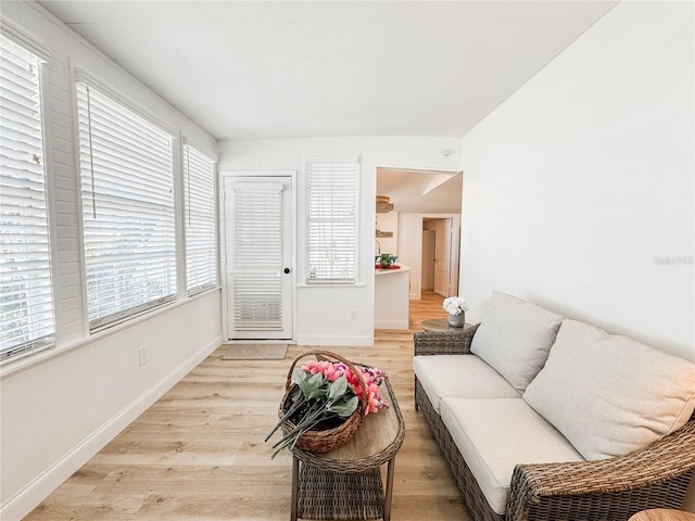 living area featuring light wood-style flooring and baseboards